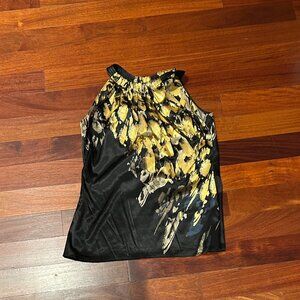 Tahari sleeveless halter blouse featuring a black background with an abstract